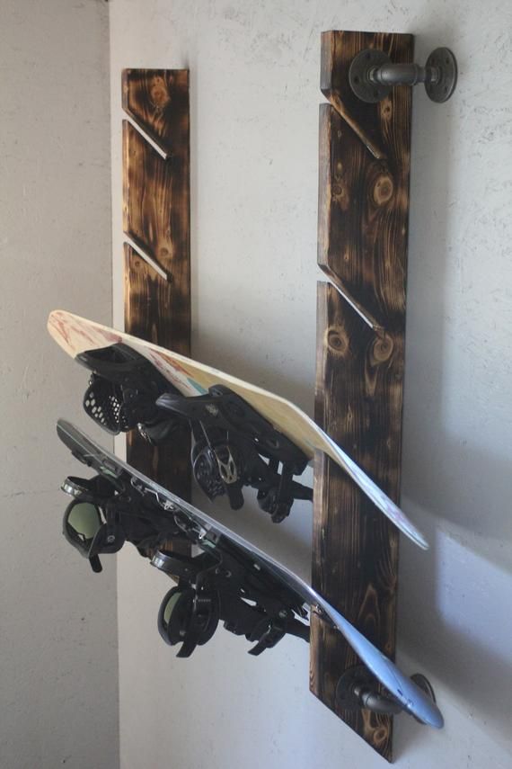 there is a snowboard and skis hanging on the wall