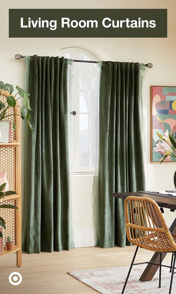 living room curtains with green drapes in front of a table and chair next to a window