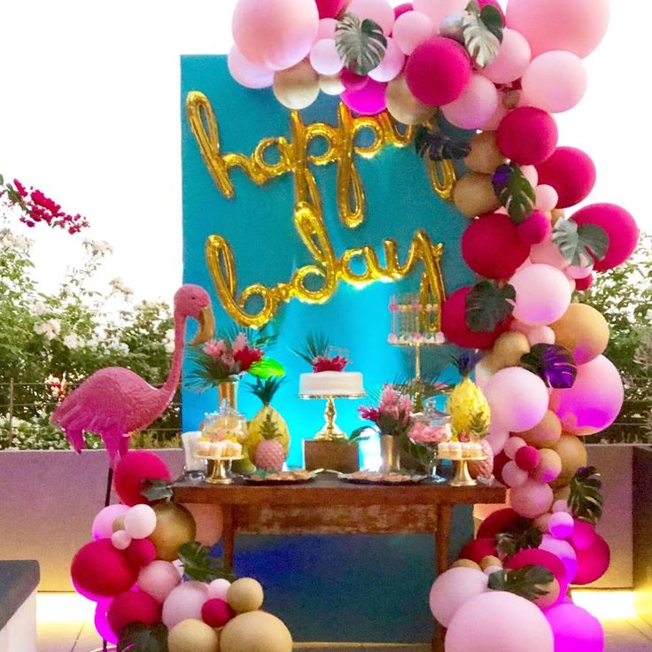 a birthday party with flamingos and balloons