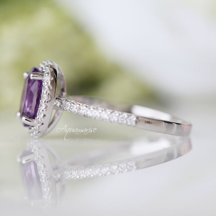 Gorgeous Lavender Amethyst Ring ►Made of Sterling Silver, Rhodium Plated (S925) ►Accented with Simulated Diamonds Center Stone: Amethyst Color: Purple Stone Cut: Oval Gem size: 8.0 x 6.0 mm Gemstone Creation: Natural ►Handling time: 1-2 business days ►Free domestic USA shipping ►Wrapped & ready to give in a beautiful box. Anniversary Emerald Halo Ring, Emerald Halo Ring For Anniversary, Emerald Cut Halo Ring For Anniversary, Oval Halo Ring For Anniversary With Halo Design, Classic Oval Halo Ring For Anniversary, Classic Purple Ring As Gift, Classic Purple Rings As Gift, Classic Princess Cut Halo Ring For Anniversary, Classic Gemstone Cluster Ring For Anniversary