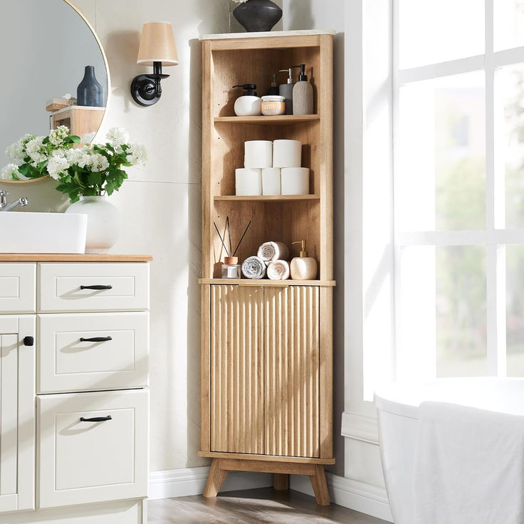 a bathroom with a wooden cabinet next to a sink and mirror on the wall above it