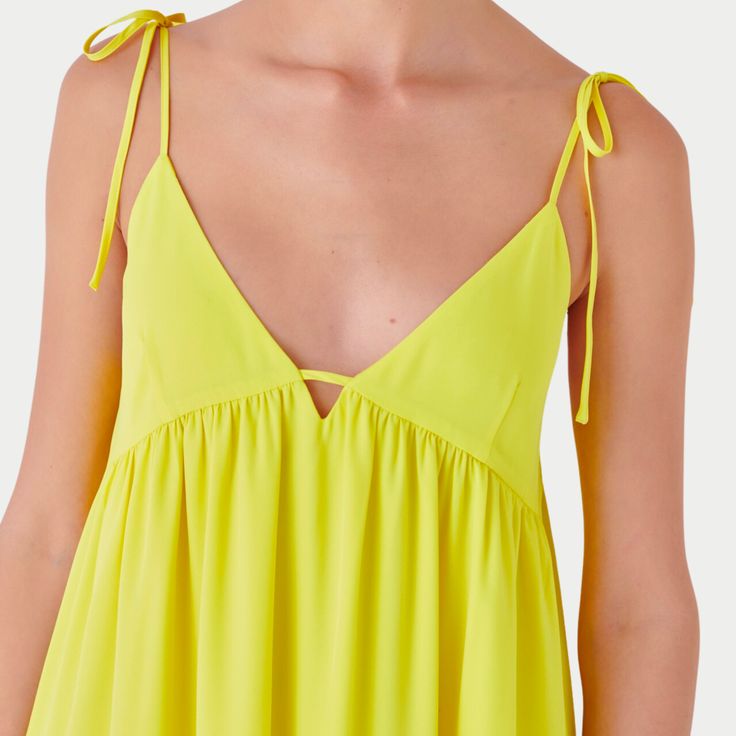 Capture the vibrancy of summer with the Nicola Maxi Dress, a radiant addition to your wardrobe. This sleeveless, floor-grazing dress is a celebration of sunny days with its eye-catching hue and elegant V-neck design. The functional spaghetti bow tie adds a playful yet sophisticated touch, allowing for a personalized fit. The side zipper and back elastic band ensure ease of wear and comfort, while the full lining provides a smooth silhouette. Key Features: Maxi Length: Offers a sweeping, elegant statement. Sleeveless Cut: Perfect for staying cool and showcasing arms. Functional Spaghetti Bow Tie: Adds charm and adjustability. V-Neck Line: Flatters the neckline and adds a hint of allure. Convenient Side Zipper: For a seamless fit. Fabric Contents: Polyester, Spandex The Nicola Maxi Dress wit V-neck Dresses For Summer Parties, Vibrant V-neck Midi Dress For Brunch, Spring A-line Sleeveless Dress For Beach, Chic Summer Maxi V-neck Dress, Summer Sundress For Summer Parties, Sleeveless Dresses For Summer Parties, Flowy V-neck Summer Dress For Day Out, Summer A-line Maxi Dress For Beach Season, Flowy V-neck Sleeveless Sundress