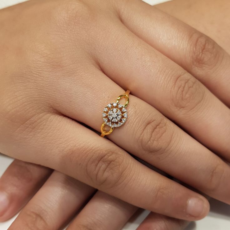 a woman's hand with a diamond ring on it