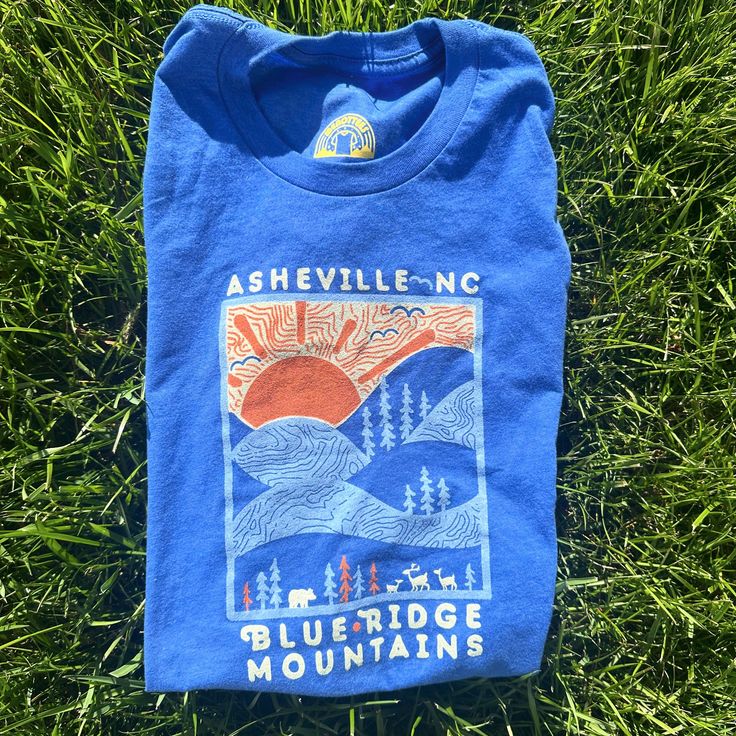 A Day in the Blue Ridge Mountains Unisex (Fits True To Size) - Super Soft and Comfy with a Lived-In Feel - 52% Cotton // 48% Poly - Original Design - Ethically Sourced from WRAP Certified Facilities  - Hand-Screened in Asheville, North Carolina Blue Short Sleeve T-shirt For Outdoor, Blue Graphic Tee For Outdoor Activities, Blue Crew Neck Top For Outdoor Activities, Blue Screen Print Tops For Outdoor Activities, Blue Tops With Screen Print For Outdoor Activities, Blue Screen Printed Tops For Outdoor Activities, Blue Cotton Tops For Outdoor Activities, Blue Outdoor Tops With Screen Print, Blue Graphic Print Top For Outdoor Activities