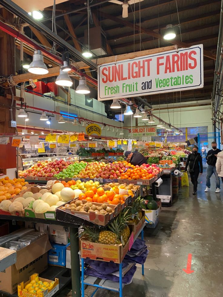 an indoor market filled with lots of fresh fruits and vegetables