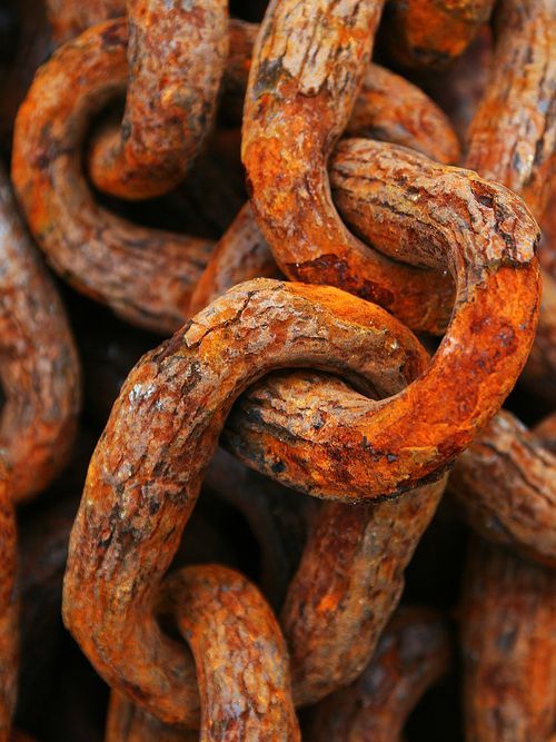 an old rusty chain is shown close up