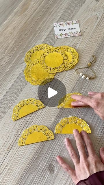 a video demonstrating how to make paper doily with scissors and glue on wood flooring