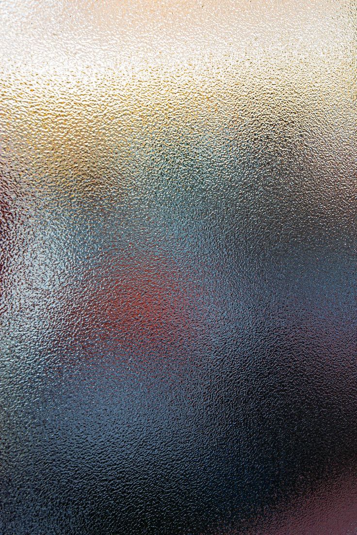 a close up view of frosted glass with red, yellow and blue colors on it