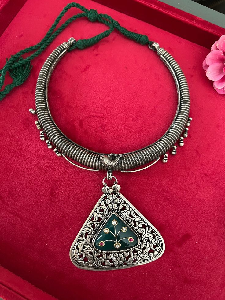 NEW ARRIVALS ♥️ An heirloom antique pure 925 silver necklace! For all silver jewelry lovers, Shivka showcases traditional treasures with unmatched craftsmanship. Beautiful Kundan work on the Green onyx stone is the highlight of this pendant necklace.  The elegant pendant Hasli necklace is Purely handmade with love by our skilled Indian craftsmen from Jaipur in real silver with antique polish and semi-precious stones. Adjustable  Comes with an adjustable Dori.  Metal Purity: Hallmarked 925 Silver Weight of necklace: 155 grams Traditional Metal Necklaces For Celebrations, Festive Temple Jewelry In Silver, Vintage Necklace For Festivals And Celebrations, Antique Locket Jewelry For Festivals, Ornate Ceremonial Hallmarked Necklace, Handmade Silver Kundan Necklace, Festive Silver Kundan Necklace With Oxidized Finish, Silver Kundan Necklace With Intricate Design, Elegant Silver Kundan Necklace With Oxidized Finish