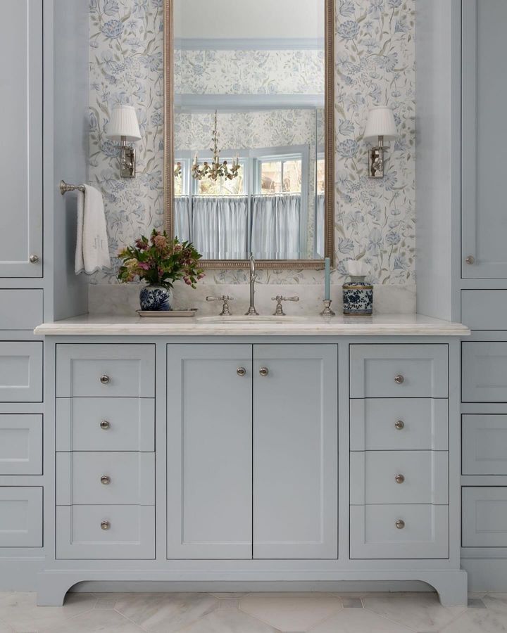 a bathroom vanity with two sinks and a large mirror over it's top cabinet