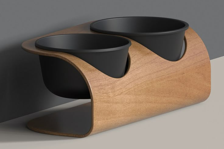 two black cups are sitting on a wooden stand