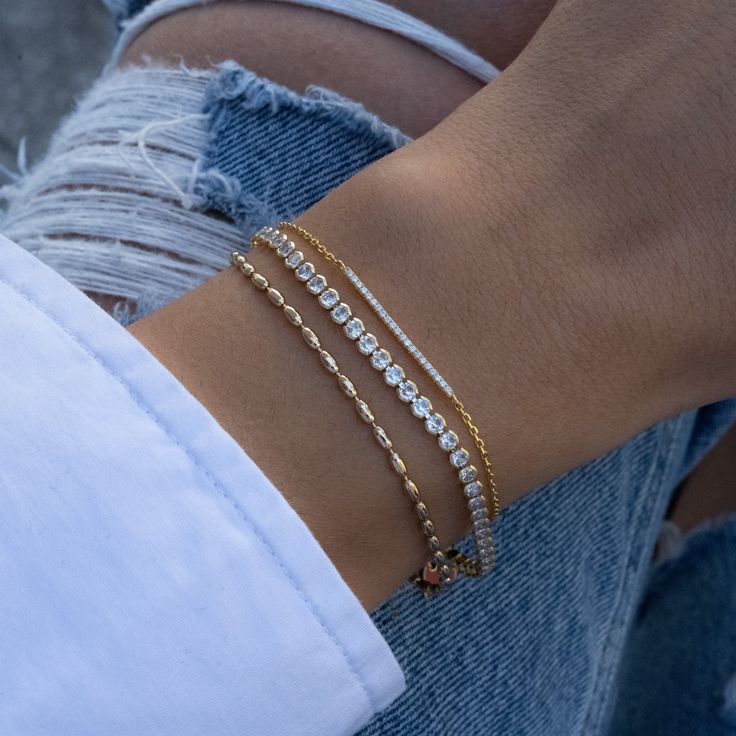 Super cute beaded bracelet is great for layering or worn on its own! Delicate & chic makes it a great accessory! Made of 925 Sterling Silver THICK plating of 14k Gold or Rhodium Available in 6.25", 6.75" or 7" + .5" Ext Chain lengths 2mm Rice Beads Nickel-free & Hypoallergenic Lobster clasp closure with extension chain Bracelets on Model: Tennis Bracelet, Pavé Bar Bracelet Rice Bead Bracelet, Jewelry 2024, Bar Bracelet, Gold Armband, Rice Bead, Chain Bracelets, Jewelry Lookbook, Bar Bracelets, Tennis Bracelet