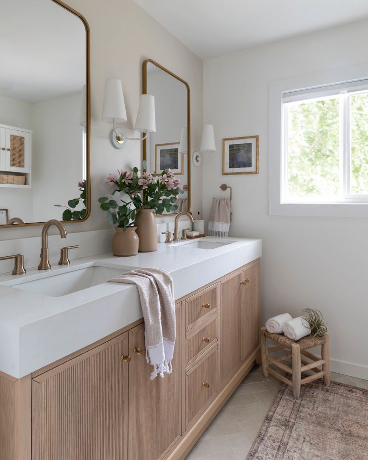 a large bathroom with two sinks and mirrors