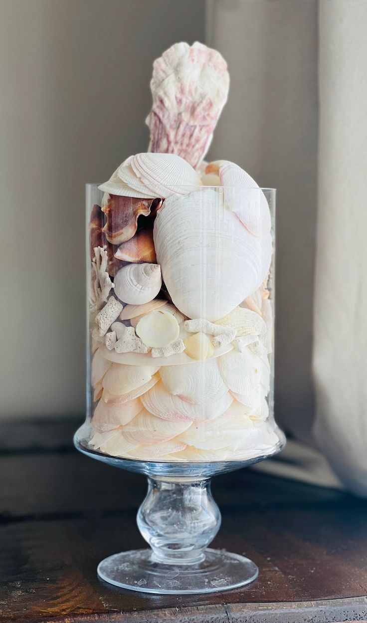 there is a glass cake with shells in it