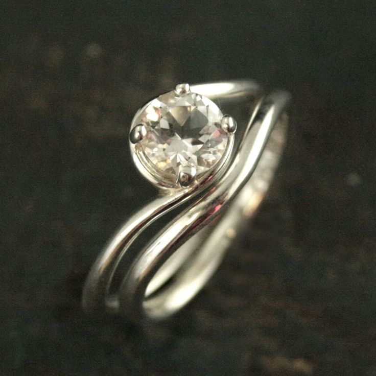 a close up of a ring with a diamond on it