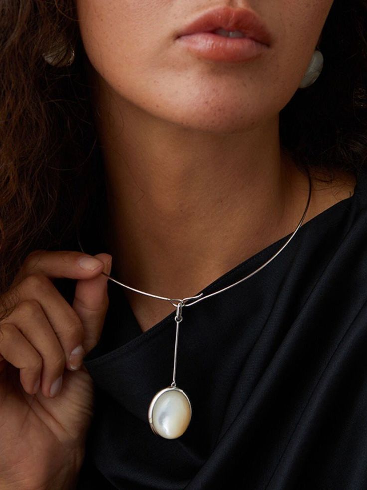 Elevate your style with our White Mother of Pearl Pendant Sterling Silver Choker! This modern and fashionable choker is perfect for urban women, with its textured and light atmosphere. It beautifully accentuates both the neck and face, with simple circles and neat lines. The large oval pendant adds a touch of gentleness and strength. Metal: 925 Sterling Silver Gemstone: White Mother of Pearl/Wood Grain Stone/Black Onyx Inner Diameter: 13cm Inner Circumference: 410mm Weight: 16.5g Modern Pendant Choker As Gift, Elegant Sterling Silver Everyday Choker, Elegant Sterling Silver Choker, Elegant Sterling Silver Choker For Everyday, Modern Sterling Silver Choker As Gift, Elegant Everyday Sterling Silver Choker, Modern Sterling Silver Choker For Gift, Modern Silver Choker For Everyday, Modern Sterling Silver Choker Necklace