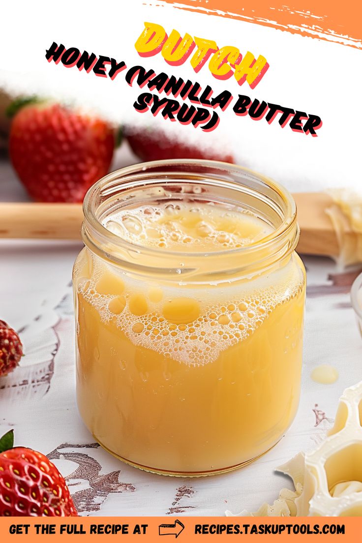 a jar filled with honey vanilla butter next to sliced strawberries