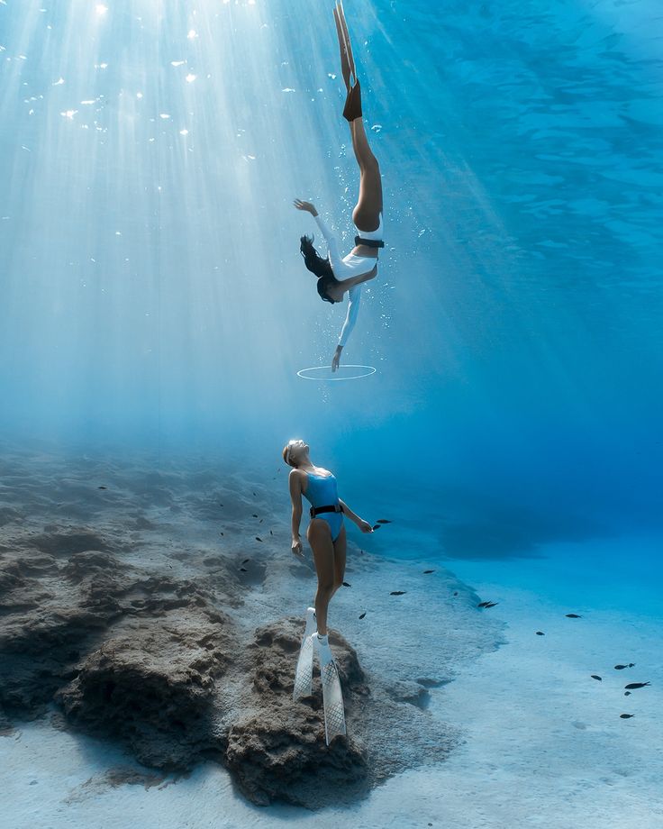 two women are diving in the ocean together