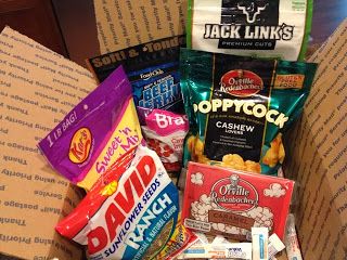 an open box filled with snacks and candy