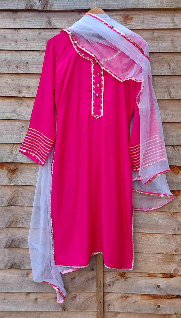 Hot pink suit set for women.  Set of 3 kurta, payjama and dupatta.  Suitable for festive wear like for rakhi, janmasthmi and diwali.  Can be matched as mum and daughter outfit. Sizes available -  THESE ARE GARMENT MEASUREMENTS (IN INCHES) Size 8 - XS - Bust 32, Waist 24 Size 10 - S - Bust 34, Waist 26 Size 12- M - Bust 36, Waist 28 Size 14 - L - Bust 38, Waist 30 Size 16 - XL - Bust 40, Waist 32 Size 18 - XXL -Bust 42, Waist 34 Disclaimer - This product is made to order. Product colour may sligh Unstitched Pink Kurta For Eid, Pink Unstitched Kurta For Eid, Festive Pink Lawn Suit With Gota Work, Pink Salwar Kameez With Dabka Work, Traditional Pink Lawn Suit With Straight Kurta, Pink Lawn Suit With Dabka Work Straight Kurta, Pink Salwar Kameez With Dabka, Straight Kurta, Pink Straight Kurta For Festive Occasions, Pink Straight Kurta With Dabka Work