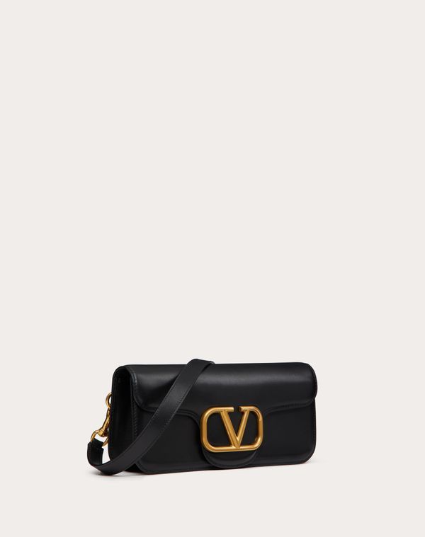 Valentino Garavani Locò calfskin crossbody bag. - Logo and antique brass-finish hardware - Magnetic closure - Open inside pocket - Adjustable and removable shoulder strap - Dimensions: W27xH12xD6 cm - Valentino Garavani logo - Drop length: 50 cm - Made in Italy Luxury Crossbody Baguette Bag With Adjustable Strap, Luxury Crossbody Baguette Bag, Luxury Shoulder Baguette Bag With Detachable Strap, Luxury Crossbody Baguette Bag With Removable Pouch, High-end Everyday Luxury Crossbody Shoulder Bag, Luxury Crossbody Shoulder Bag With Detachable Strap, Designer Crossbody Shoulder Bag With Gold-tone Hardware, Luxury Baguette Bag With Gold-tone Hardware For Travel, Luxury Crossbody Shoulder Bag With Gold-tone Hardware