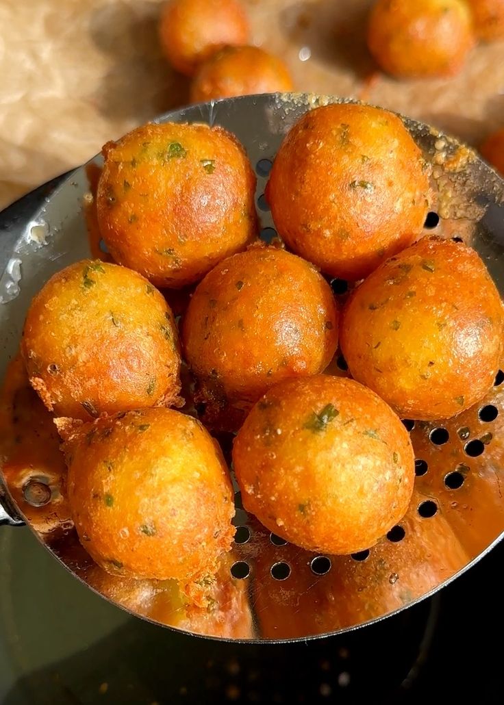 some food is being cooked in a colander