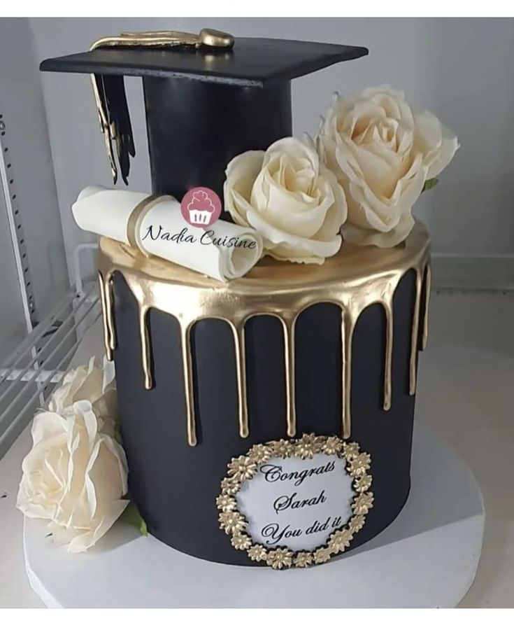 a graduation cake decorated with white roses and chocolate icing