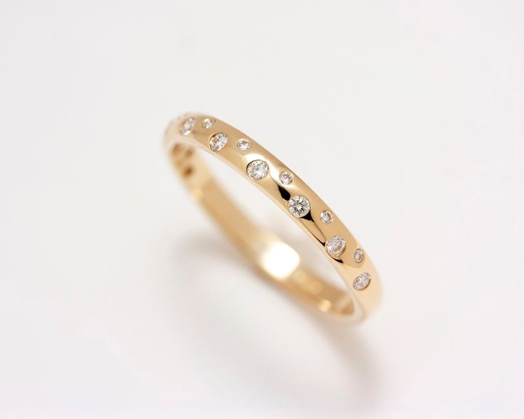 a gold ring with small diamonds on it