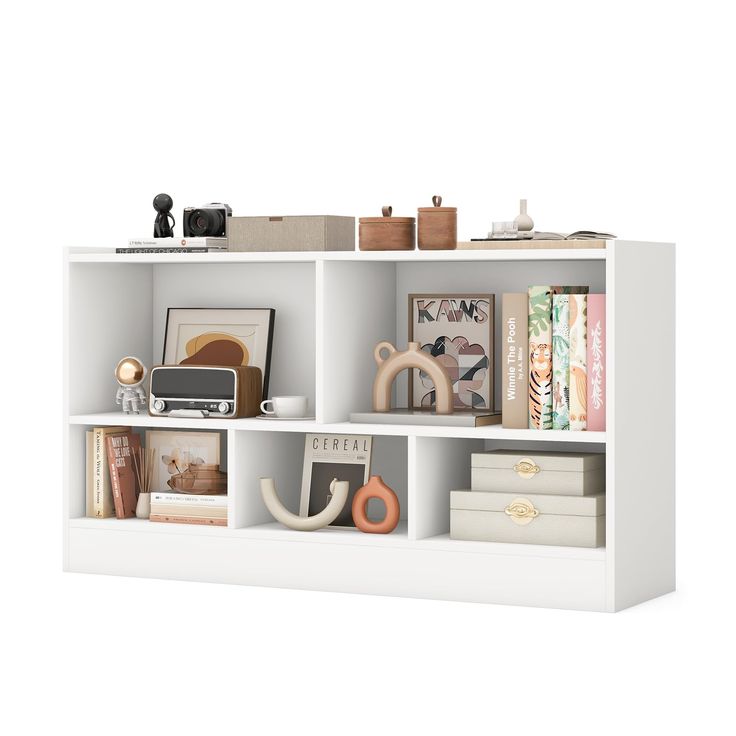 a white book shelf filled with lots of books and knick - knacks