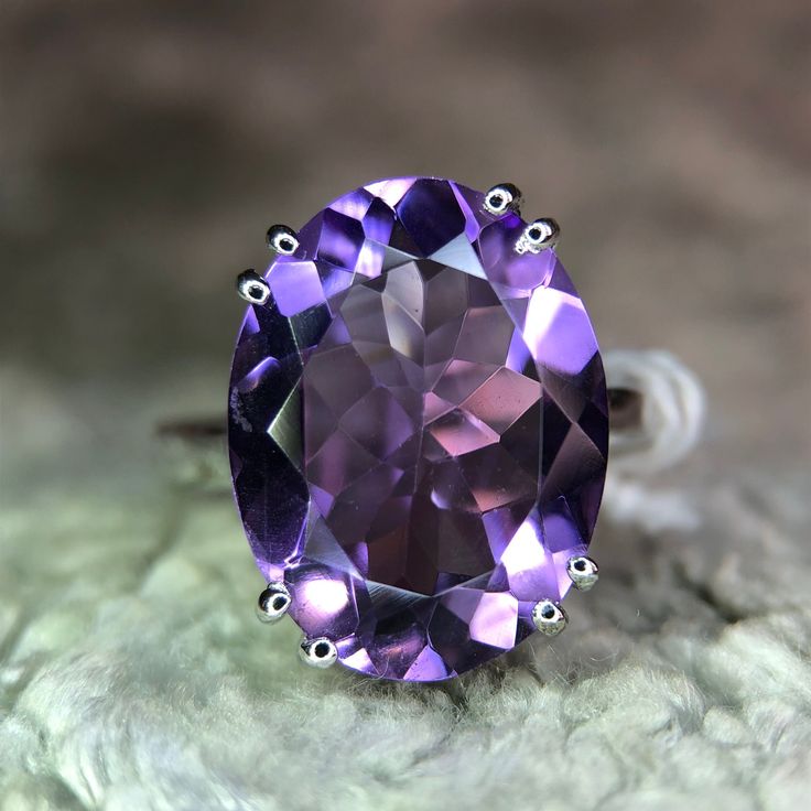 Discover the elegance of our designer natural amethyst ring, crafted in 925 sterling silver. This exquisite piece features a stunning natural amethyst gemstone, renowned for its deep violet hue and spiritual significance. The intricate designer setting showcases the gemstone's beauty while ensuring durability and comfort. Perfect for any occasion, this ring adds a touch of sophistication to your jewelry collection. Whether as a personal treat or a thoughtful gift, this amethyst ring is sure to i Elegant Amethyst Crystal Ring In White Gold, Elegant White Gold Amethyst Crystal Ring, Elegant Purple Topaz Ring In Sterling Silver, Elegant Amethyst Ring For A Gift, Elegant Formal Amethyst Ring With Large Stone, Elegant Large Stone Amethyst Ring, Elegant Formal Amethyst Ring Stamped 925, Classic Amethyst Ring As A Gift, Luxury Oval Amethyst Ring In Sterling Silver