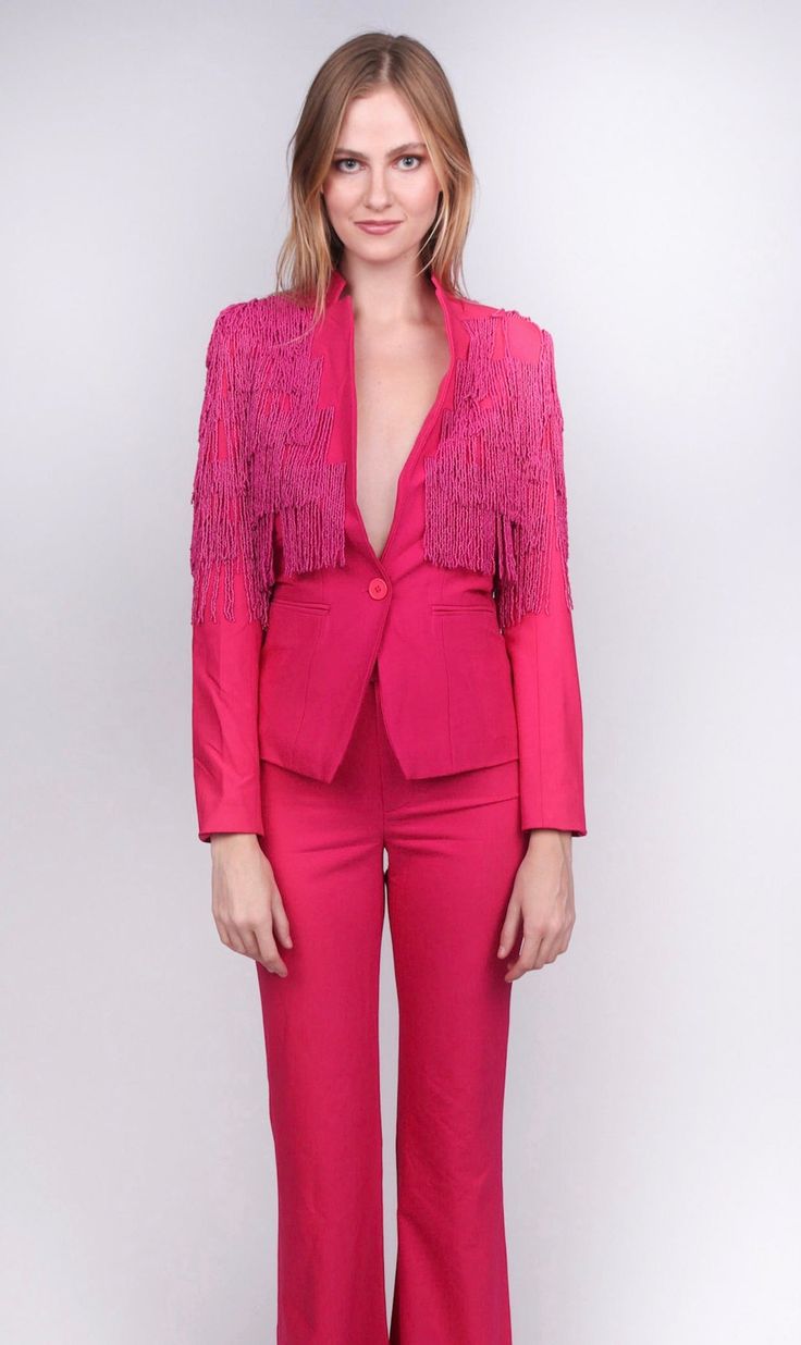 Who wants to simply feel "pretty in pink" when you can be looking perfect in it! The Any Old Iron Pink Fringe Suit elevates a pink ensemble from being cute to being drop dead gorgeous by utilizing a feminine silhouette and subtle details that are sure to blow the crowd away. This hot pink blazer and fit and flare trouser combo makes a statement with its rich utilization of color and through the fringe that cascades down the shoulders. This fringe consists of hand-assembled, beaded strands, which Hot Pink Blazer, Hot Pink Blazers, Pink Blazer, Flare Trousers, Feminine Silhouette, Feel Pretty, Suit Accessories, Bubblegum Pink, Satin Fabric