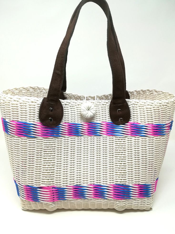 Handwoven by local artisans in Guatemala and designed by Verapaz, this tote bag is crafted from 100% recycled plastic. This colourful, practical and original tote bag is ideal for a visit to the beach, for your iPad or yoga clothes. It is a roomy essential accessory that would add a stylish touch to your outfit. Thanks to the nature and quality of the plastic it has been woven from, this tote is extremely durable and versatile. Height: 24cm Width: 37cm Depth: 15cm Handles drop: 20cm *Since our b White Handwoven Beach Bag For Travel, Eco-friendly White Beach Bag For Market, White Tote Beach Bag For Market, Casual White Handwoven Beach Bag, White Basket Beach Bag For Everyday Use, Casual Beach Bag Made From Recycled Materials, White Casual Straw Bag For Market, Casual White Beach Bag With Leather Handles, Casual White Straw Bag For Market