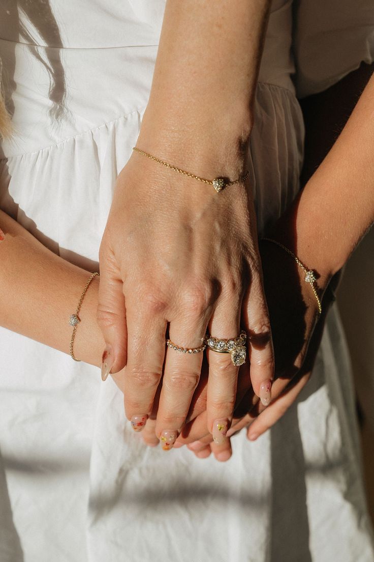 An heirloom diamond heart bracelet symbolizing true love. Each piece is hand-cast and handset in 14k solid yellow, white, or rose gold. Approximately .20 carat weight of high quality, round, brilliant diamonds in each heart (G color & VS clarity white diamonds). The Italian-milled chain is dainty, yet extremely durable. Adjustable length allows for a range of sizes and should fit most wrists. Adult/Mama Sizing: 6'' - 6.75'' max length Custom lengths and additional links are available free of cha Diamond Heart Bracelet With Diamond Accents, Diamond Heart Bracelet With Accents, Heart Shaped Diamond Bracelet With Accents, Diamond Accented Bracelets For Valentine's Day Wedding, Wedding Jewelry With Heart Charm In Cubic Zirconia, Gold Heart Bracelet With Diamond Accents, Cubic Zirconia Heart Charm Jewelry For Wedding, Wedding Bracelets With Diamond Accents For Valentine's Day, Wedding Jewelry With Cubic Zirconia Heart Charm