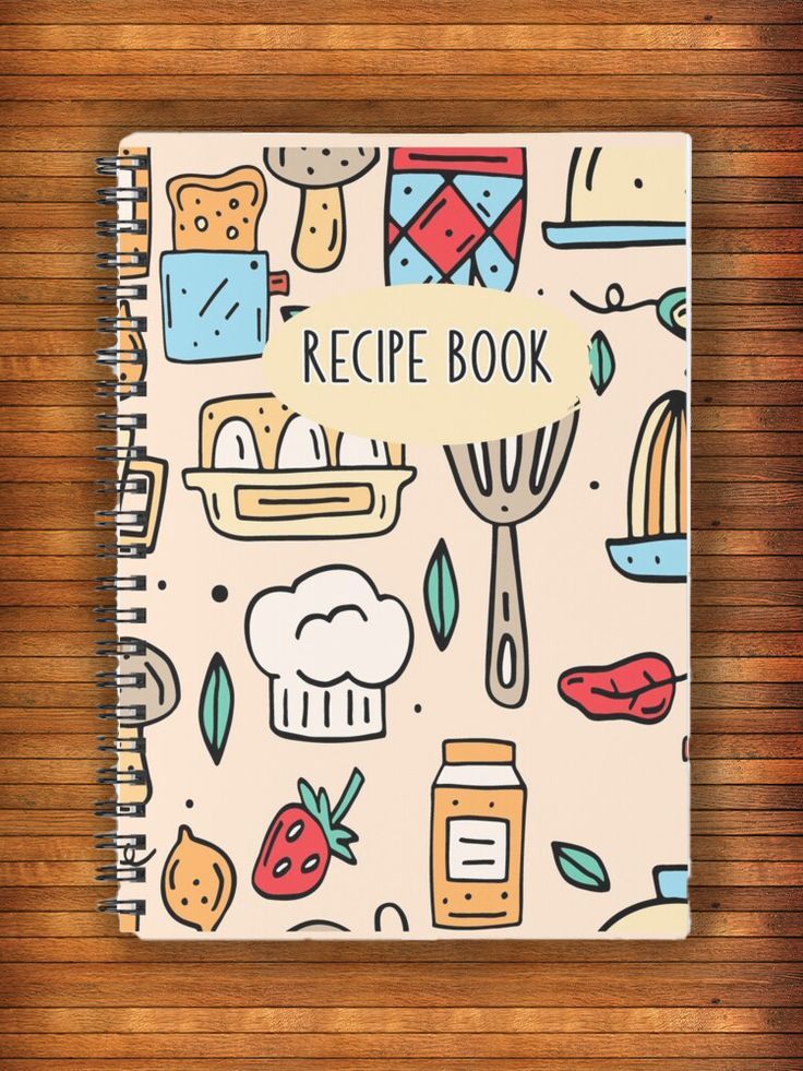 a recipe book on a wooden surface with food items around it and the words recipe book written in white