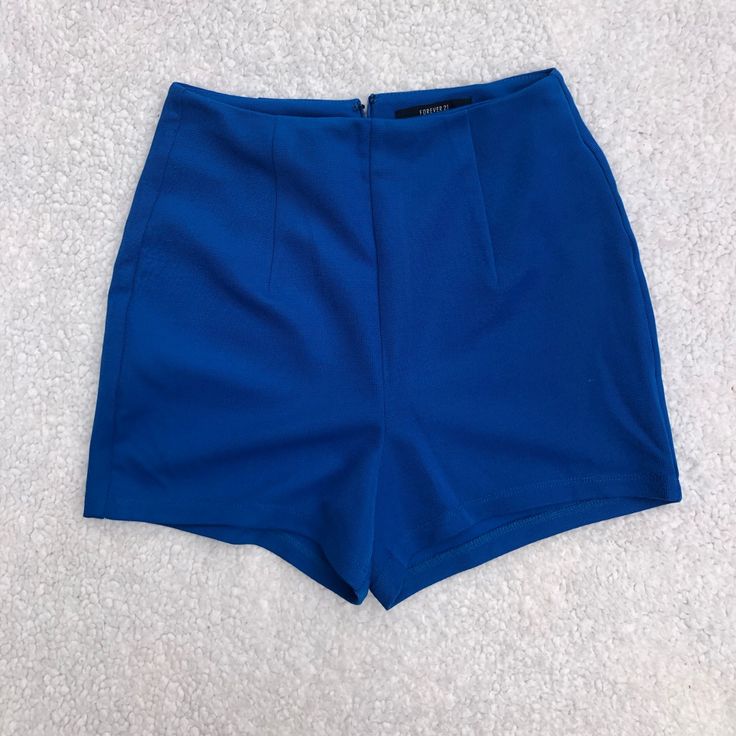 Forever21 Cobalt Blue High Waisted Short. Textured Material. Bright Bold Color. Zip Closure In Back. Size Xs, Fits Tts 00/0. Never Worn. Smoke Free Home. Inseam: 2” Waist: 11” Trendy Blue Mini Length Bottoms, Trendy Blue Mini Bottoms, Trendy Mini Shorts For Date Night, Blue Mini Bottoms With Built-in Shorts, Blue Stretch Mini Shorts, Stretch Blue Mini Shorts, Trendy Blue Shorts With Short Inseam, Chic Blue Shorts For Night Out, Chic Blue Bottoms For Date Night