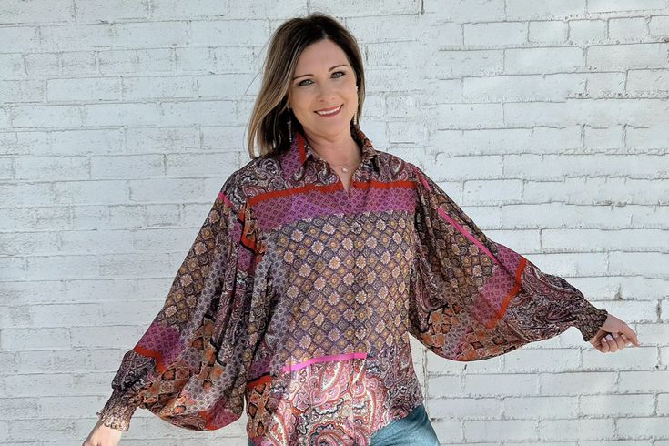 This boho-chic blouse will have you feeling like you just stepped off the runway! With a beautiful floral print, smocked cuffs, front button closure, and statement puff sleeves, you'll look stylish all season long. Look good, feel good! Bohemian Tops With Smocked Cuffs And Bishop Sleeves, Bohemian Tops With Bishop Sleeves And Smocked Cuffs, Billowy Long Sleeve Bohemian Tops, Bohemian Tops With Floral Print And Bishop Sleeves, Fall Printed Tops With Balloon Sleeves, Patterned Long Sleeve Blouse For Day Out, Bohemian Billowy Top With Blouson Sleeves, Fall Tops With Printed Balloon Sleeves, Bohemian Blouse With Bishop Sleeve And Smocked Cuffs