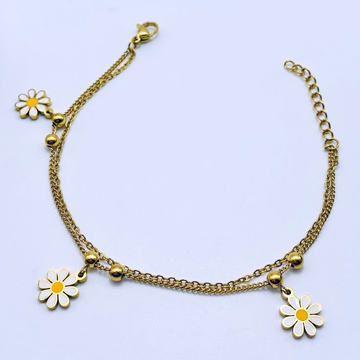 Embrace the girly charm of our Daisy Charms Bracelet and let it be your go-to accessory for every occasion. Whether worn alone or layered with other bracelets, it's sure to become a cherished favorite in your jewelry collection. Available in silver and gold. Trendy Hypoallergenic Charm Bracelet For Friendship, Everyday Bracelets With Dangling Charms, Dainty White Bracelets With Charms, Trendy Adjustable Jewelry With Flower Charm, Adjustable Trendy Jewelry With Flower Charm, Trendy Adjustable Bracelets With Dangling Charms, Dainty Metal Charm Bracelet With Extender, Trendy Adjustable Chain Bracelet With Charms, Dainty Adjustable Dangle Charm Bracelet