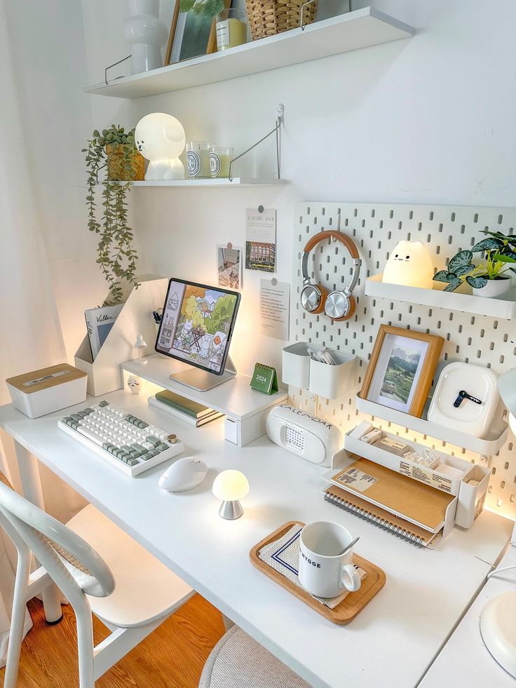 a white desk topped with a computer monitor and keyboard