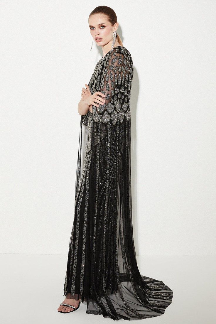 Adorned With An Abundance Of Glistening Sequins And Beads, This Floor-Sweeping Gown Is A Vision Of Ethereal Opulence. A Cascading Cape Adds A Sense Of Drama, While Mesh Details Bring An Alluring Element.Hand-Embellished Detailssheer Cape Sleevesround Necklinethis Is A Limited Edition Piece, Created As One Of Just 150 Styles. Formal Embellished Maxi Dress With Cape Sleeves, Embellished Evening Kaftan With Cape Sleeves, Glamorous Hand-embellished Dresses With Cape Sleeves, Semi-stitched Embellished Dress With Cape Sleeves, Pre-draped Cape Sleeves Evening Maxi Dress, Latest Maxi Dresses, Maxi Dress Collection, Cape Sleeves, Pink Maxi Dress