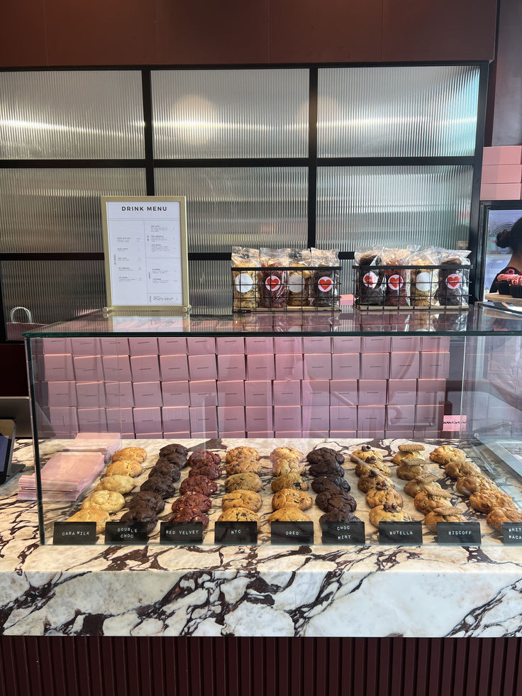 a display case filled with lots of different types of doughnuts and pastries