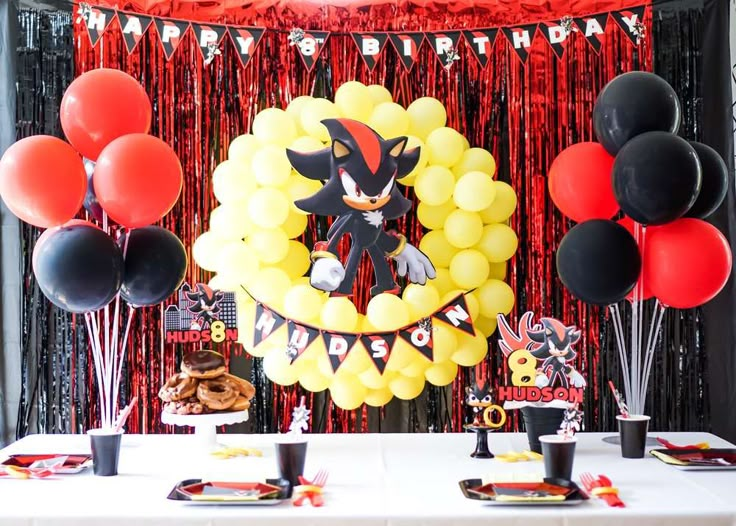 a table with balloons and decorations for a sonic the hedgehog birthday party