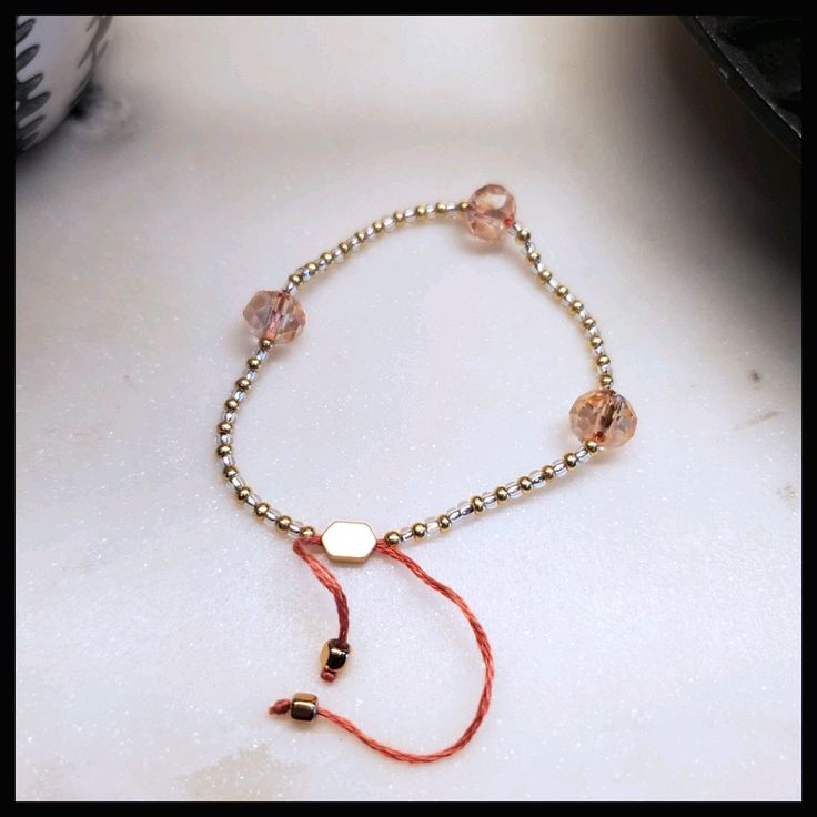 This Beautiful Bracelet Is Made With Faceted Pink, Glass Beads And Paired With Gold And Clear Seed Beads On Blush Tone Threads, And Finished Off With Gold, Metallic End Caps And Adjuster Bead. Made For Small To Medium Wrist - Can Fit Over A Hand Up To 6.5" Or 16cm At Its Widest Point. *Gift Wrap Available By Adding The Gift Wrapping Listing To Your Bundle. Adjustable Pink Gold Beaded Bracelets, Adjustable Pink Gold Beaded Bracelet, Adjustable Pink Crystal Bracelet With Round Beads, Pink Adjustable Crystal Bracelet With Round Beads, Trendy Adjustable Rose Gold Beaded Bracelets, Adjustable Trendy Rose Gold Beaded Bracelets, Adjustable Pink Gold Bracelets With Round Beads, Adjustable Pink Gold Bracelet With Round Beads, Rose Gold Beaded Friendship Bracelets With Round Beads