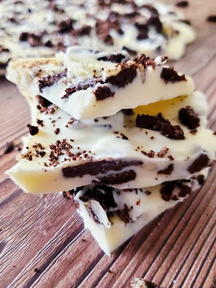 several pieces of chocolate and vanilla ice cream on a wooden table with white icing