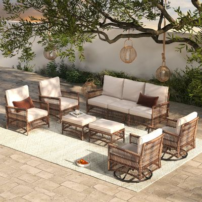 an outdoor living area with wicker furniture