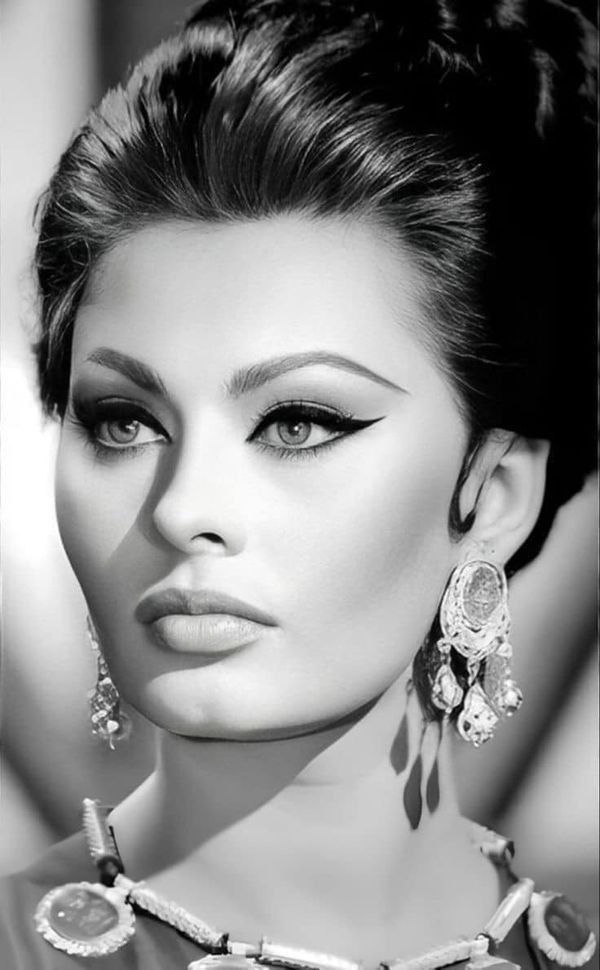 black and white photo of a woman wearing jewelry