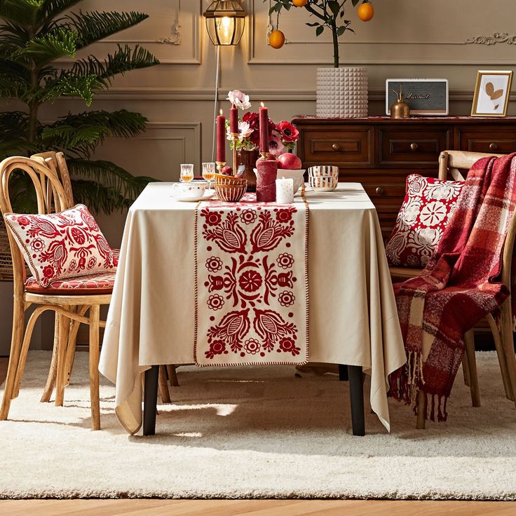 a dining room table with red and white decor