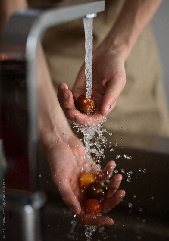 a person washing their hands under a faucet with water coming out of it