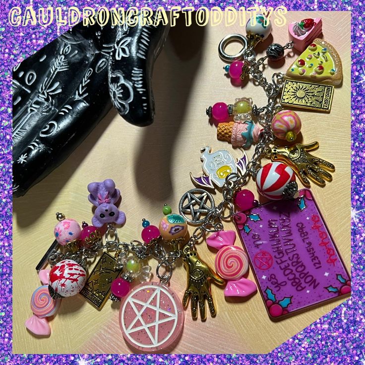 Welcome to my shop!  Here I've made a super chunky yet lightweight charm bracelet in Girlcore Spooky Slumber Party theme!  Inspired by girl gangs!  Silver tone 8" steel chain with an easy to use circle and bar toggle closure. Features pink, purple, and both gold and silver tone charms.  Friends circle round for answers and scares!  A night full of ouija boards, pizza, teddy bears, tarot, and candy...   Pink pentacles, iridescent candy beads, gold toned palm reader and tarot card charms, ice crea Handmade Pink Jewelry For Halloween, Pink Adjustable Themed Charm Bracelet, Pink Themed Adjustable Charm Bracelet, Adjustable Pink Themed Charm Bracelet, Customized Pink Novelty Jewelry, Harajuku Style Halloween Jewelry Gift, Pink Charms Bracelets Novelty Style, Pink Novelty Bracelets With Charms, Novelty Handmade Charm Bracelet For Birthday