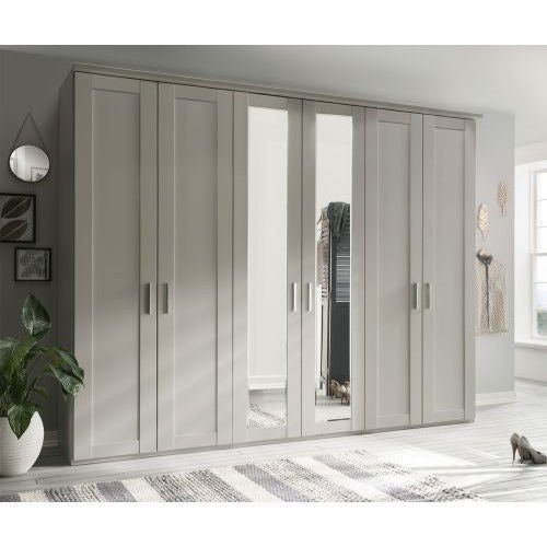 an image of a bedroom setting with white and grey wardrobes in the middle of it