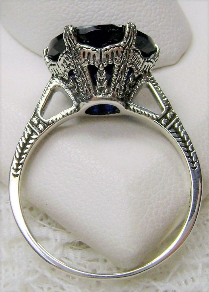 Simulated Blue Sapphire Solid Sterling Silver Ring 100 Year Design#D37 (larger version) This is an Edwardian reproduction filigree ring in antiqued solid sterling silver. The round full cut high quality Simulated Blue Sapphire solitaire gemstone is 12mm in diameter. The inside of the band is marked 925 for solid sterling silver. Notice the beautiful intricate crown-like design of the silver filigree setting and the etched band. The original ring in this exact design was circa 1910! Antique Engraved Silver Ring, Vintage Oxidized Finish Ring, Victorian Silver Engraved Ring For Formal Occasions, Antique Sterling Silver Engraved Ring, Vintage Silver Engraved Ring With Oxidized Finish, Vintage Engraved Ring With Oxidized Finish For Anniversary, Vintage Oxidized Engraved Ring For Anniversary, Vintage Engraved Sterling Silver Ring In Antique Silver, Vintage Oxidized Rings For Collectors